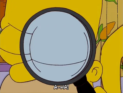 Homer finds a clue with his magnifying glass
